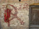 chillies drying on faded maoist slogan