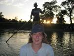 crossing the river by dug out canoe at sunset