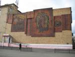 Heather admires a big mural in a Siberian train station